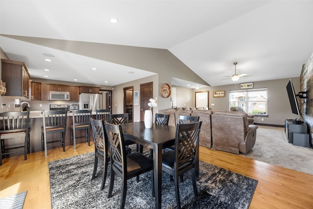 dining area with vaulted ceiling, light wood finished floors, a ceiling fan, and recessed lighting