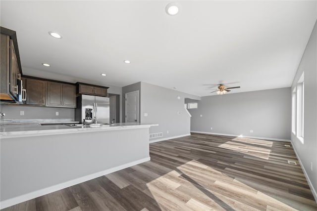 4803 Dostal Ct, Cedar Rapids, IA 52404 - kitchen with stainless steel appliances, dark brown cabinetry, light countertops, dark wood-style floors, and recessed lighting