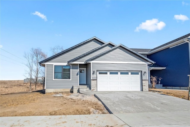 ranch-style house featuring an attached garage and driveway
