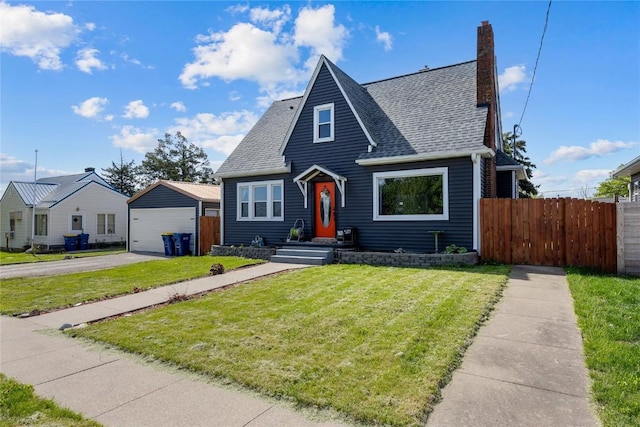 507 2nd St E, Newhall, IA 52315 - bungalow-style house featuring a shingled roof, a detached garage, a chimney, and an outbuilding
