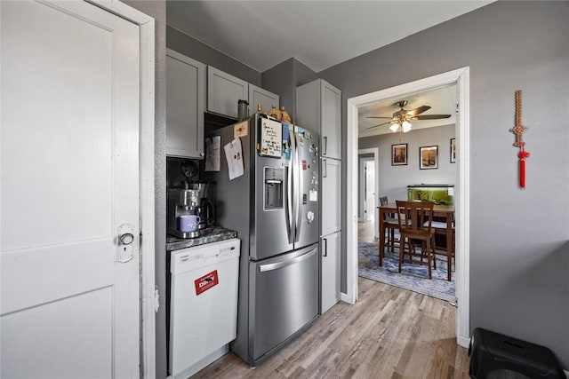 507 2nd St E, Newhall, IA 52315 - kitchen with stainless steel fridge with ice dispenser, white dishwasher, light wood-style floors, ceiling fan, and dark countertops