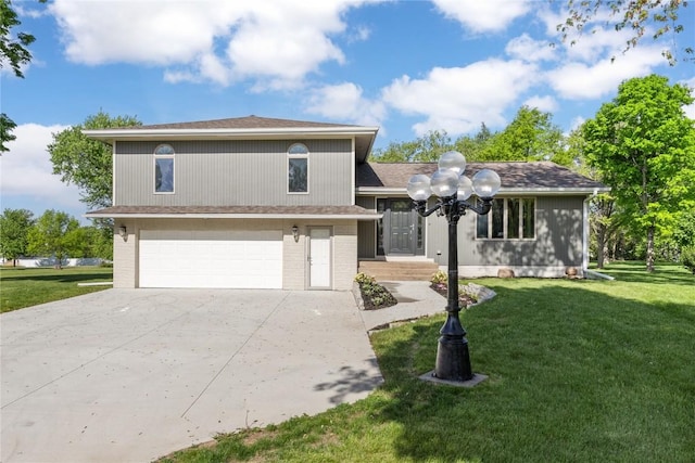 tri-level home featuring concrete driveway, a front yard, and an attached garage