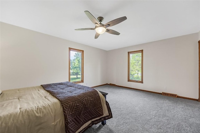 carpeted bedroom featuring baseboards and ceiling fan