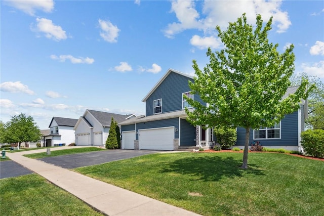 view of front of house with driveway, a front yard, and an attached garage