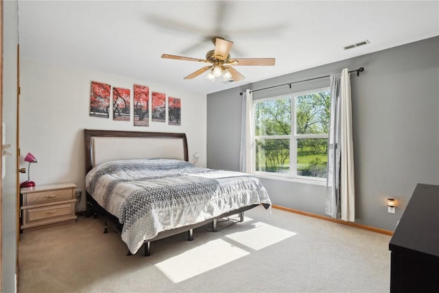 carpeted bedroom featuring baseboards and ceiling fan