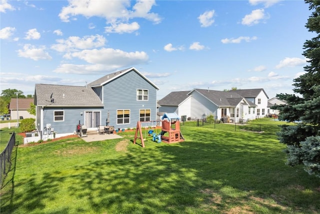 back of property with a playground and a patio area