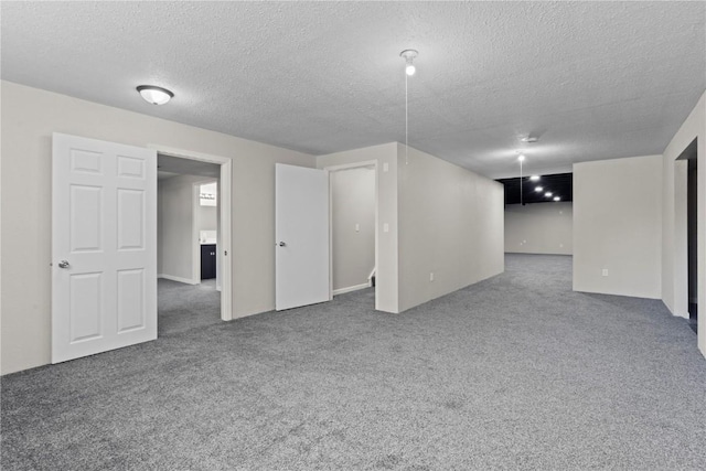 basement with carpet flooring and a textured ceiling