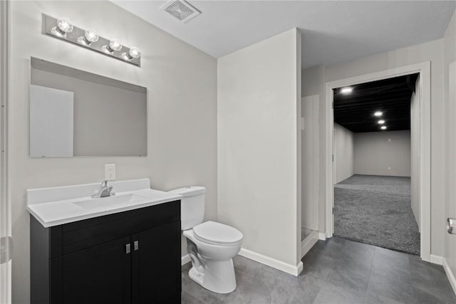full bath featuring vanity, toilet, and baseboards
