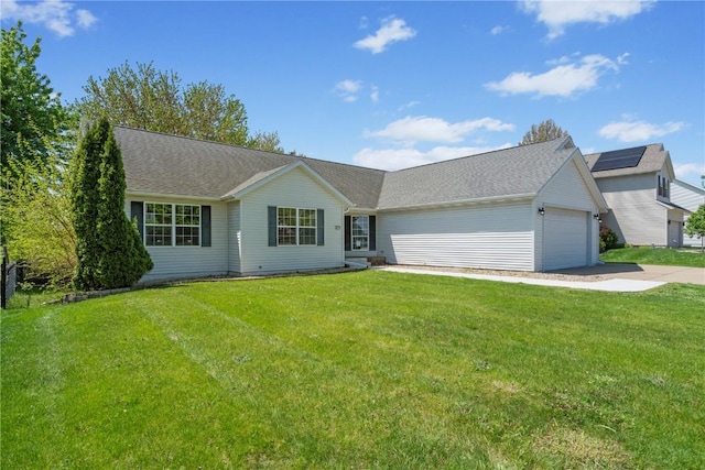 view of front of property featuring a garage, concrete driveway, and a front lawn