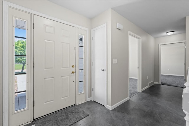 foyer featuring baseboards