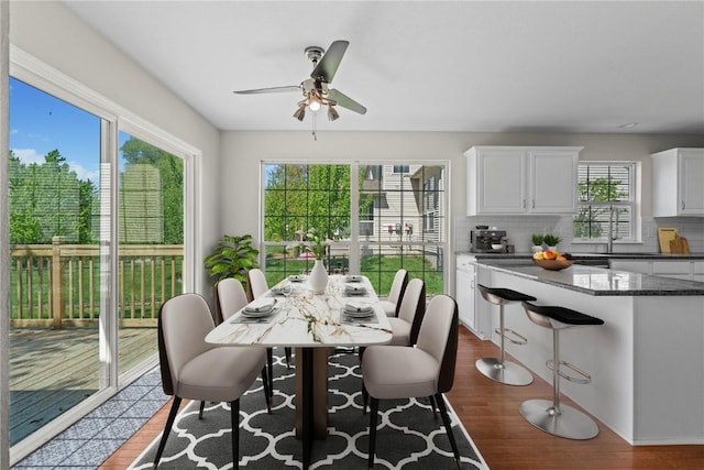 dining area featuring plenty of natural light, ceiling fan, and dark wood-style floors