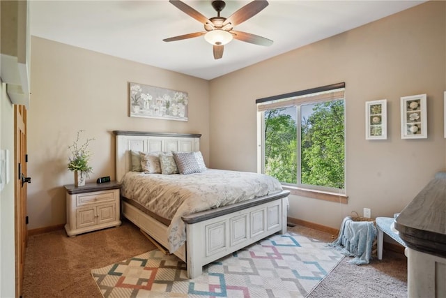bedroom with light carpet, baseboards, and a ceiling fan