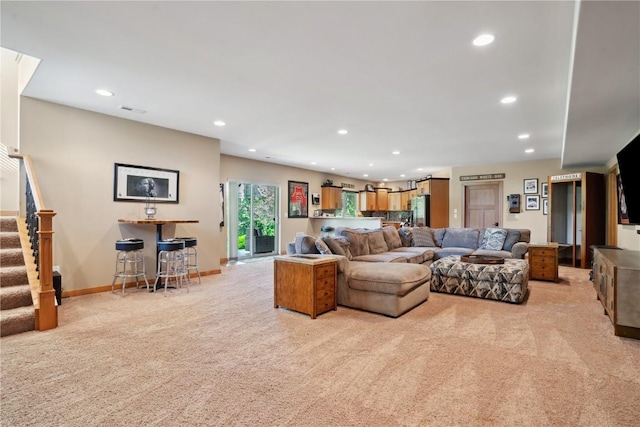 living room featuring light colored carpet, recessed lighting, stairs, and baseboards