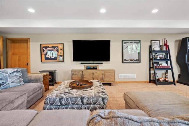 carpeted living area featuring baseboards and recessed lighting