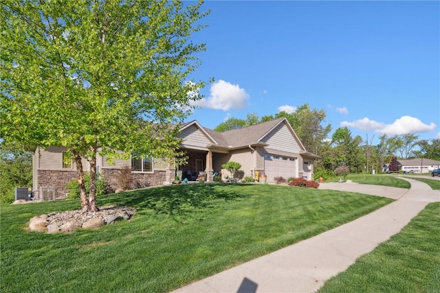 craftsman-style house featuring an attached garage, a front lawn, stone siding, and driveway