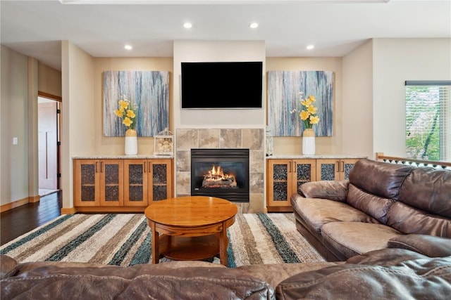 living area featuring a fireplace, wood finished floors, and recessed lighting