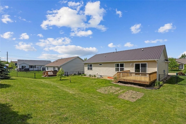 back of property featuring a wooden deck and metal roof