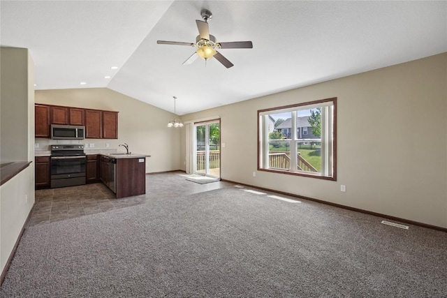 kitchen with electric stove, stainless steel microwave, open floor plan, lofted ceiling, and a peninsula