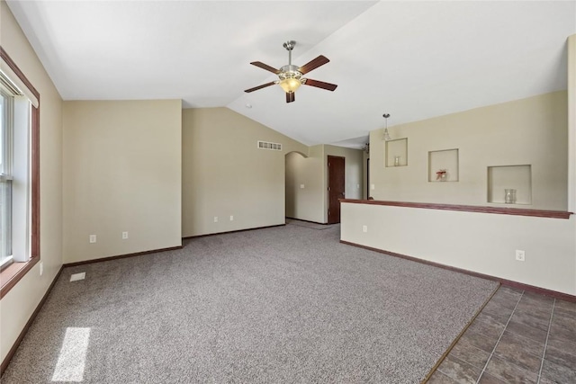 spare room with ceiling fan, lofted ceiling, baseboards, and carpet flooring