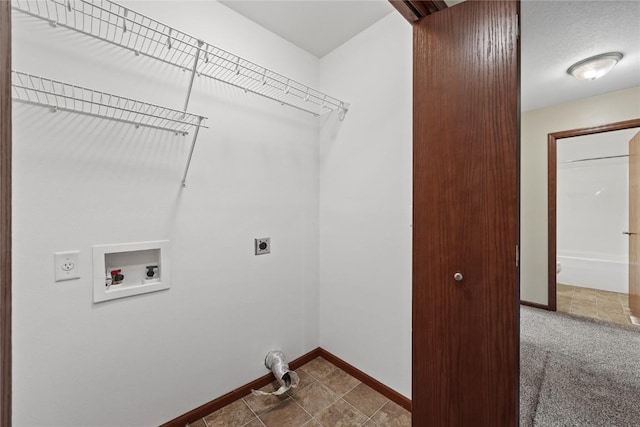 laundry area featuring electric dryer hookup, washer hookup, and baseboards