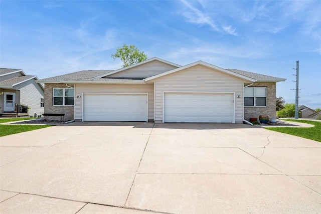 view of front of house featuring concrete driveway and an attached garage