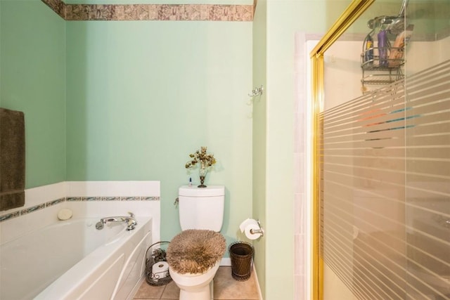 full bathroom featuring toilet, a stall shower, a bath, and tile patterned floors
