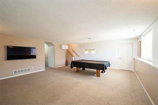 rec room featuring carpet flooring, a textured ceiling, billiards table, arched walkways, and baseboards