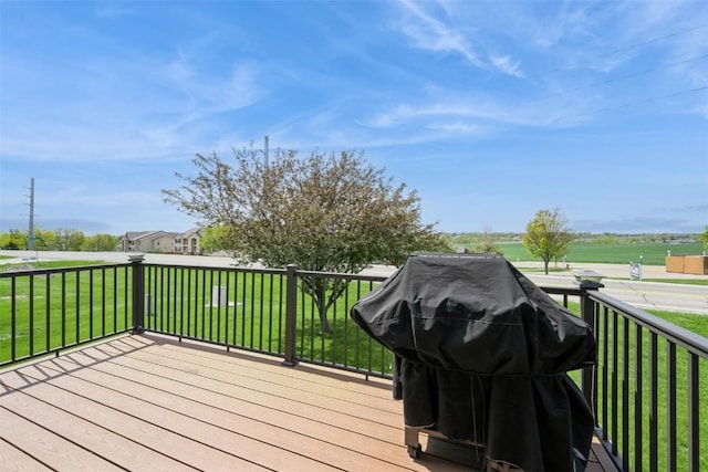 wooden deck with a lawn and grilling area