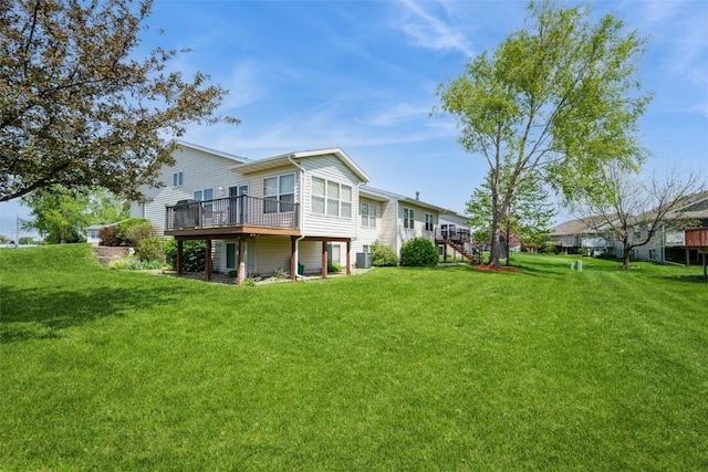 rear view of property featuring a wooden deck, a yard, and central air condition unit