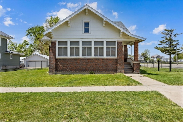 bungalow-style house featuring brick siding and a detached garage