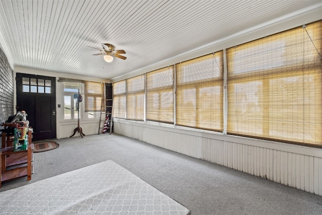 unfurnished sunroom with ceiling fan