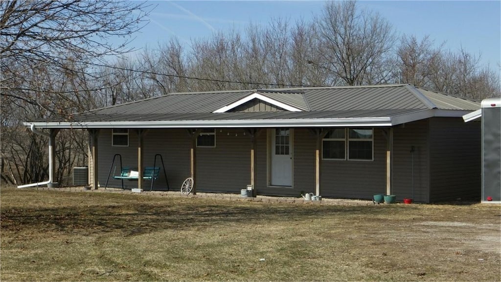 view of front of property with metal roof and cooling unit