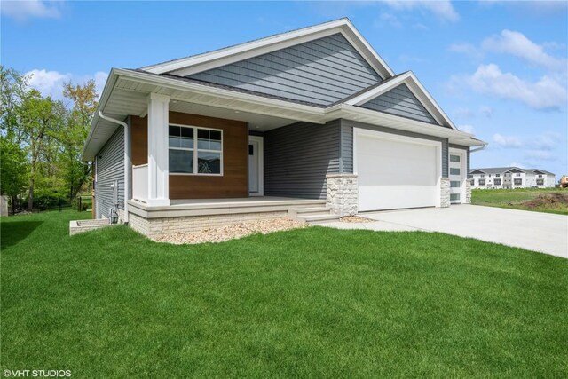 2740 Burns Dr, Marion, IA 52302 - view of front of property with a porch, a front lawn, a garage, driveway, and stone siding