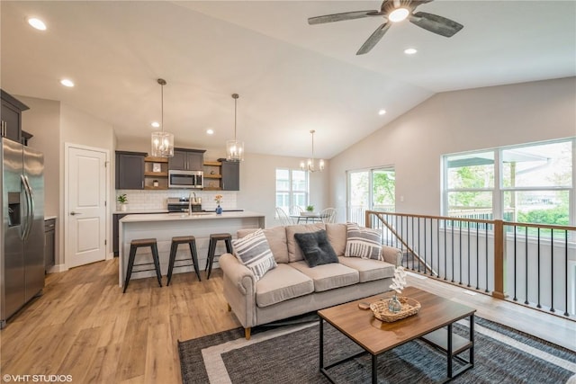 2740 Burns Dr, Marion, IA 52302 - living room featuring light wood-style flooring, lofted ceiling, a chandelier, ceiling fan, and recessed lighting