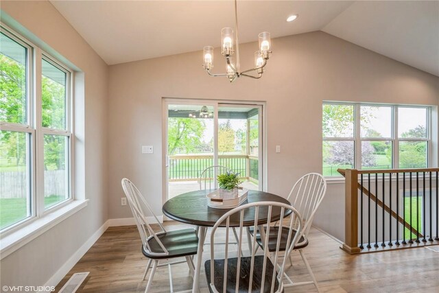 2740 Burns Dr, Marion, IA 52302 - dining space with a chandelier, lofted ceiling, baseboards, and wood finished floors