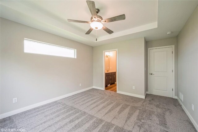 2740 Burns Dr, Marion, IA 52302 - unfurnished bedroom featuring carpet floors, a raised ceiling, baseboards, and ensuite bath