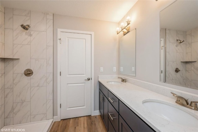 2740 Burns Dr, Marion, IA 52302 - full bathroom featuring tiled shower, wood finished floors, and double vanity