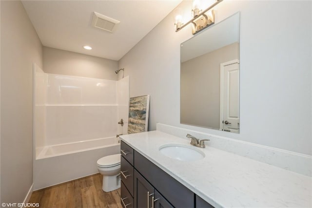2740 Burns Dr, Marion, IA 52302 - full bathroom with toilet, wood finished floors, vanity, and washtub / shower combination