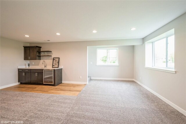 2740 Burns Dr, Marion, IA 52302 - indoor wet bar featuring light colored carpet, wine cooler, plenty of natural light, baseboards, and recessed lighting