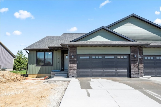 3850 Quail Trail Dr, Marion, IA 52302 - view of front facade with a garage, driveway, board and batten siding, and a shingled roof