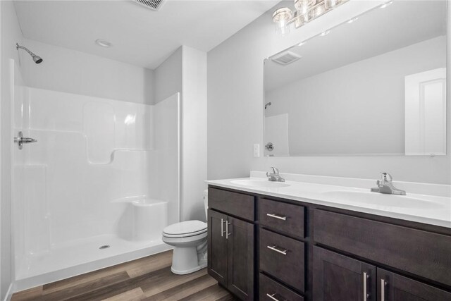 3850 Quail Trail Dr, Marion, IA 52302 - full bath featuring wood finished floors, a shower, toilet, and double vanity