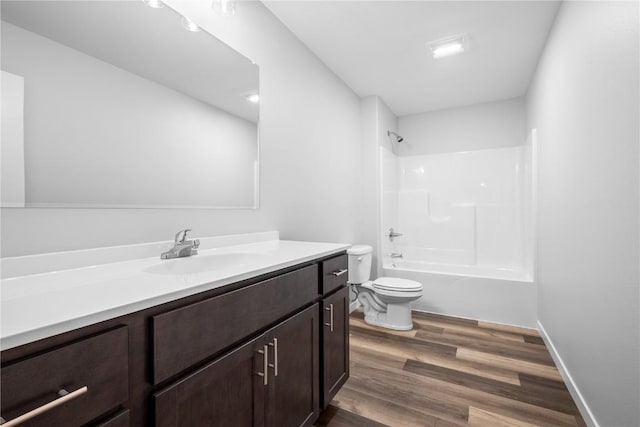 3850 Quail Trail Dr, Marion, IA 52302 - full bathroom with toilet, wood finished floors, vanity, and washtub / shower combination