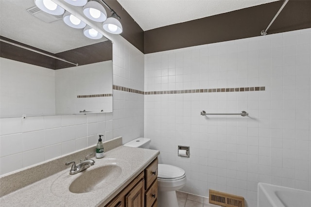 full bath featuring tile walls, toilet, vanity, shower / tub combination, and tile patterned flooring