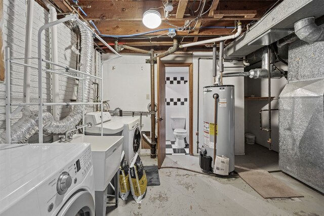 unfinished basement with gas water heater, washing machine and dryer, and heating unit