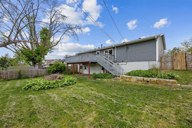 rear view of house with stairway and a wooden deck
