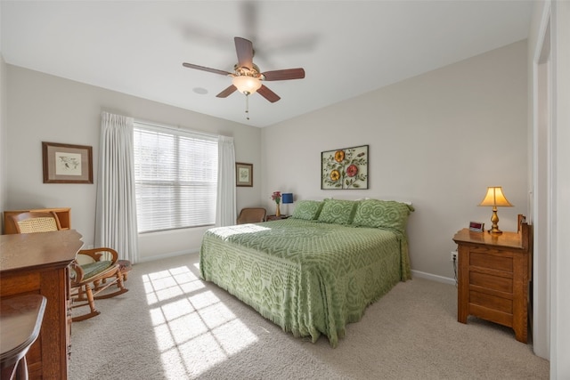 carpeted bedroom featuring baseboards and ceiling fan