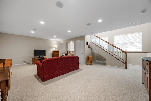 living room with light carpet, baseboards, recessed lighting, stairway, and healthy amount of natural light