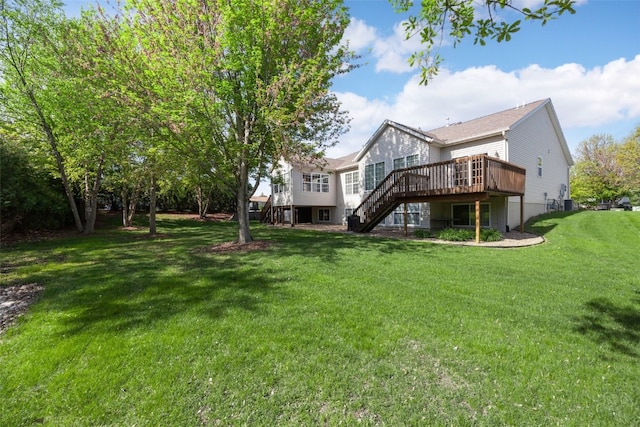back of property featuring stairway, a deck, a yard, and central AC unit