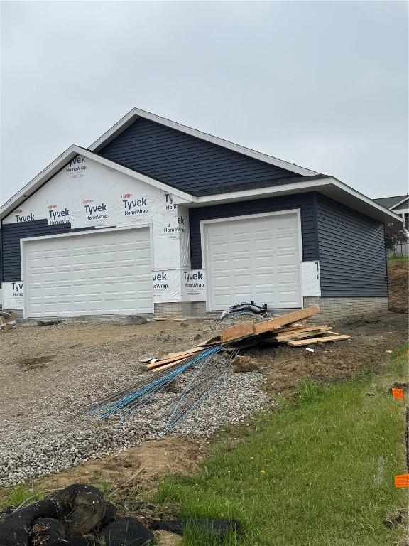 206 Endeavor Ave, Urbana, IA 52345 - unfinished property featuring a garage