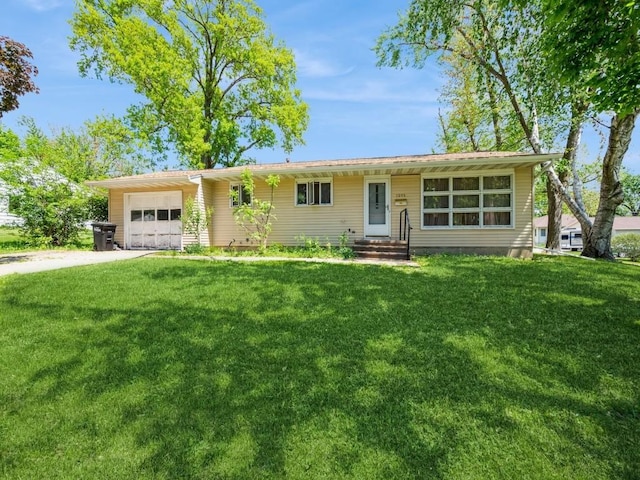 ranch-style house with an attached garage, driveway, and a front lawn